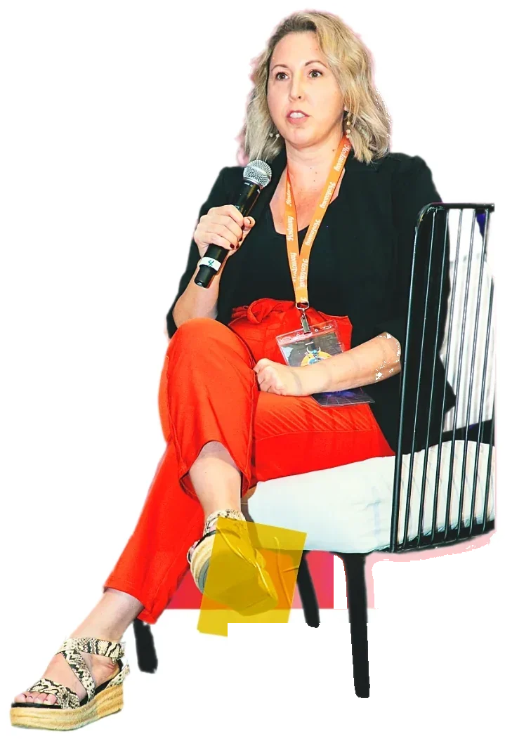 Sarah Stahl speaking on stage with a microphone